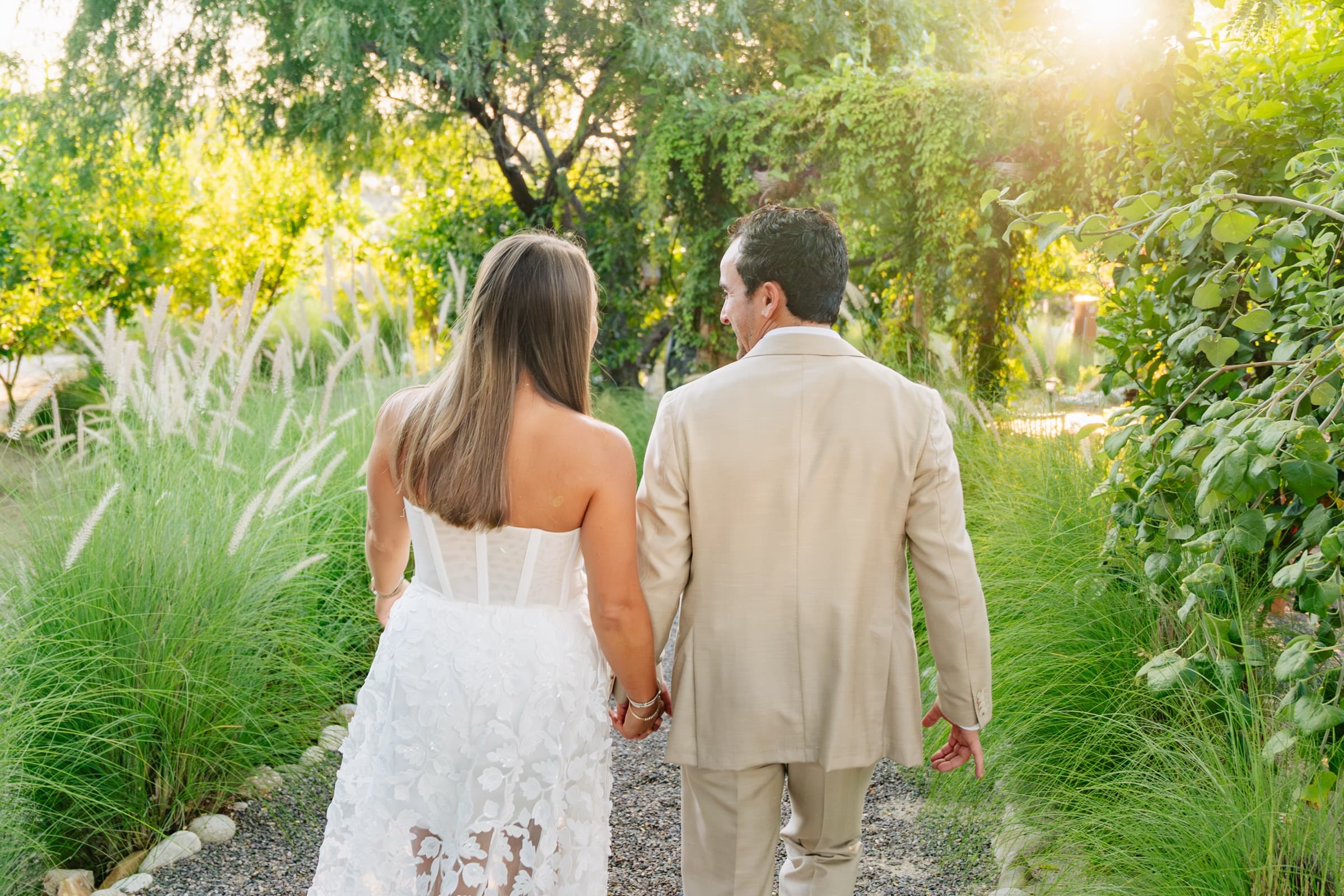 Walking hand in hand down a garden path at sunset
