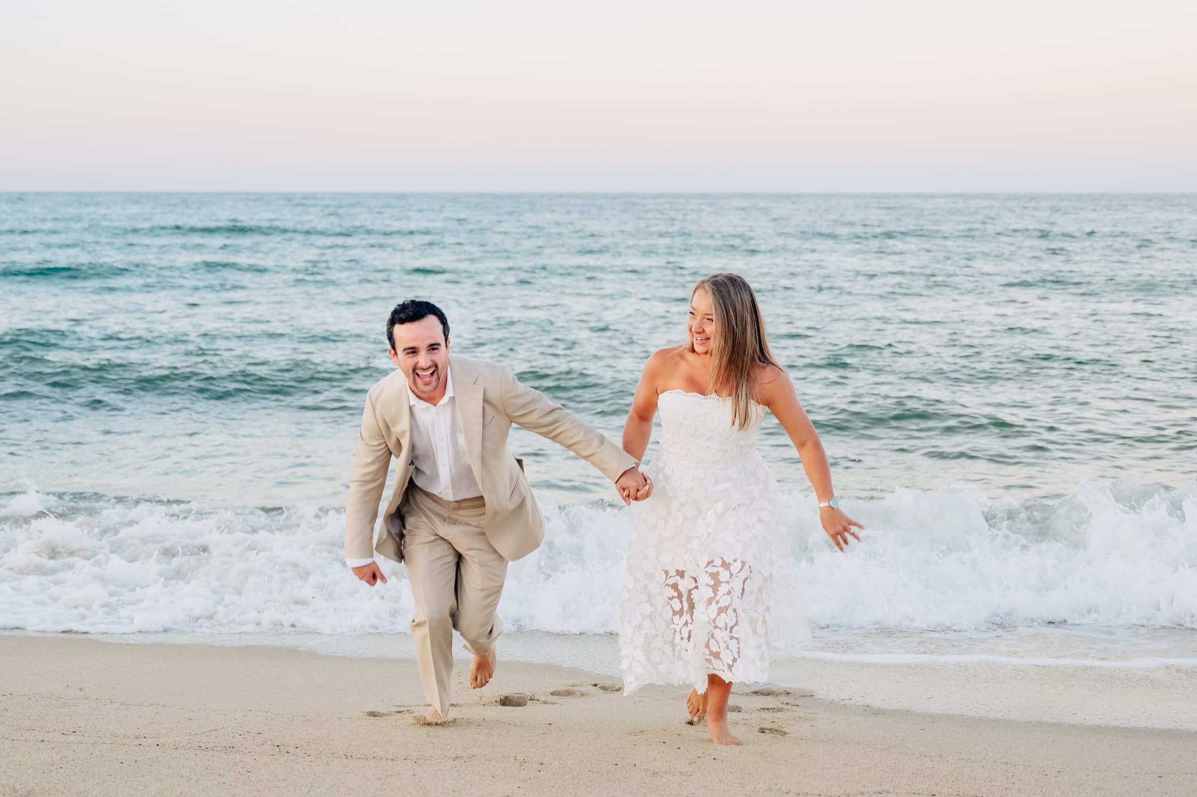 Running barefoot through the waves laughing on the beach
