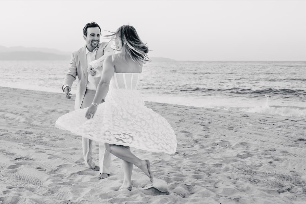 Taylor and Jeffrey on beach, playful chase moment