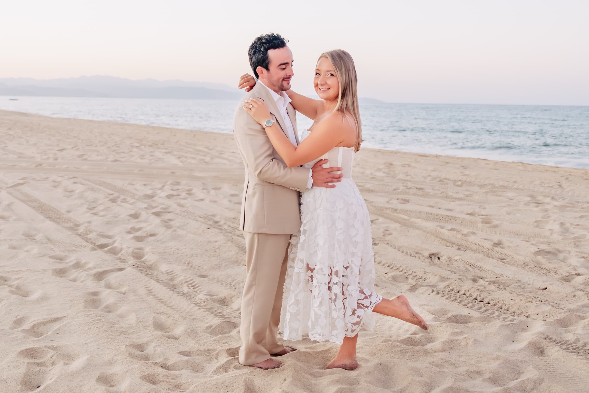 Taylor kicking up her foot on the beach at sunset