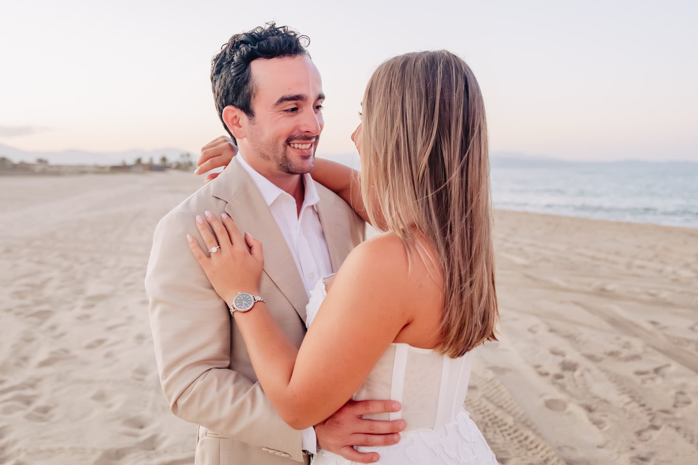 Close-up on the beach with Taylor's hand on Jeffrey's shoulder