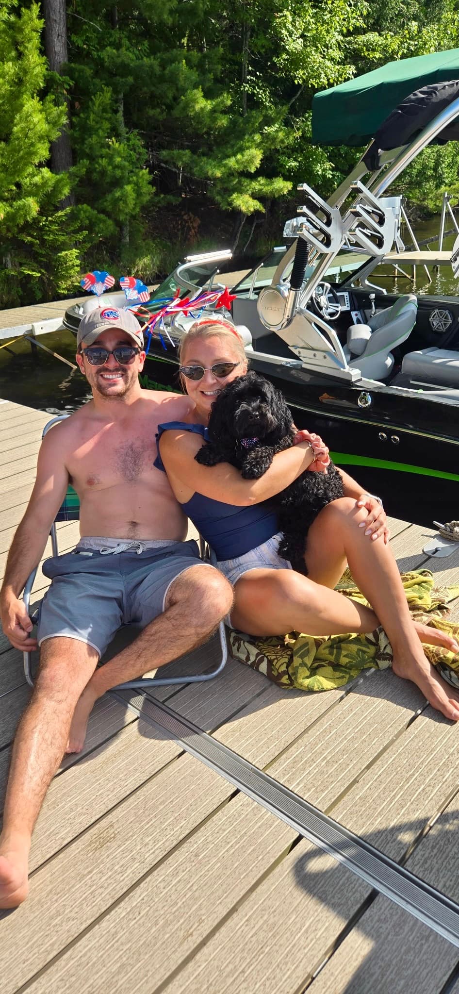 Lounging on the dock with their dog by the lake on July 4th