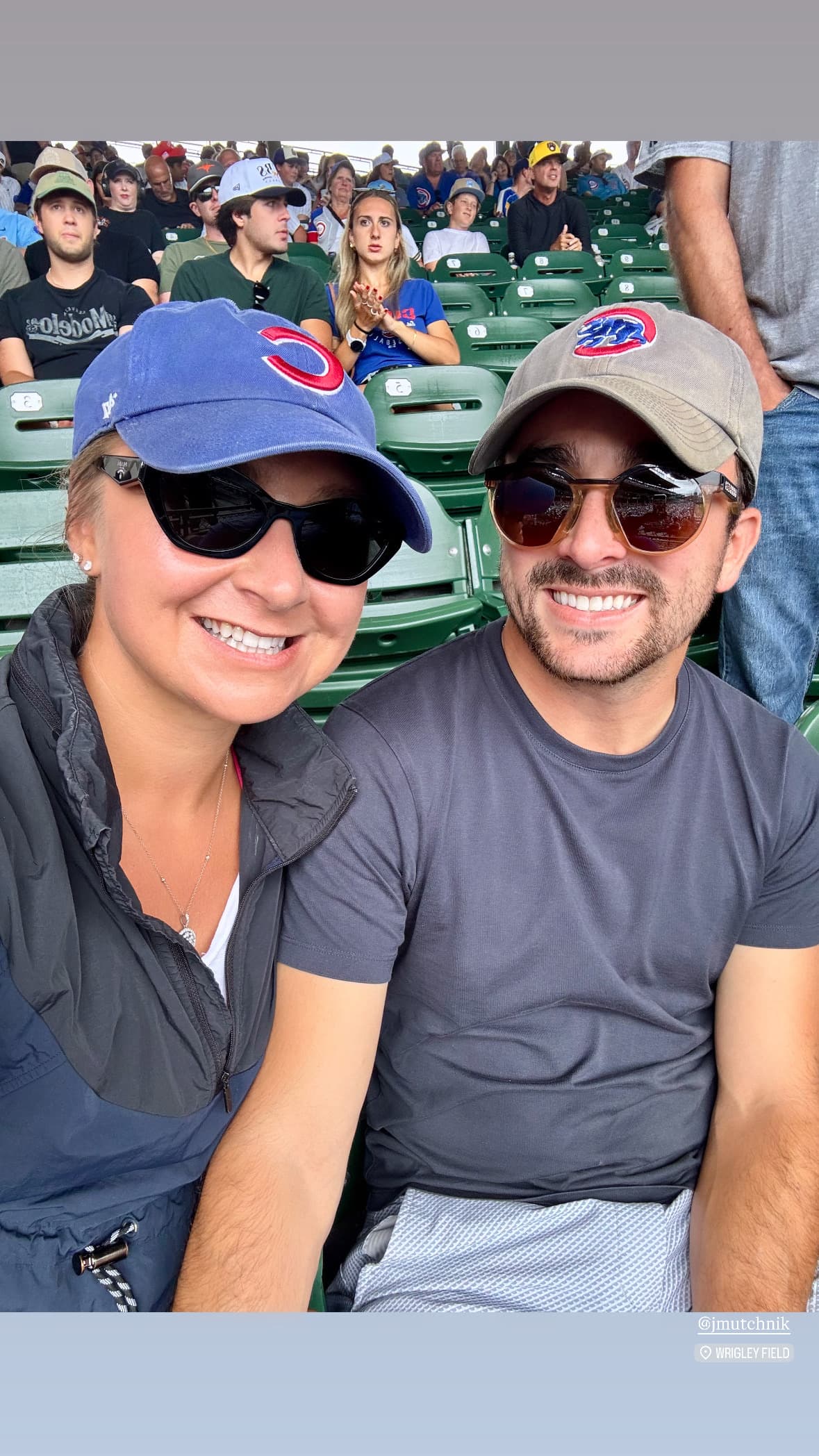 Selfie at a Cubs game in matching baseball caps
