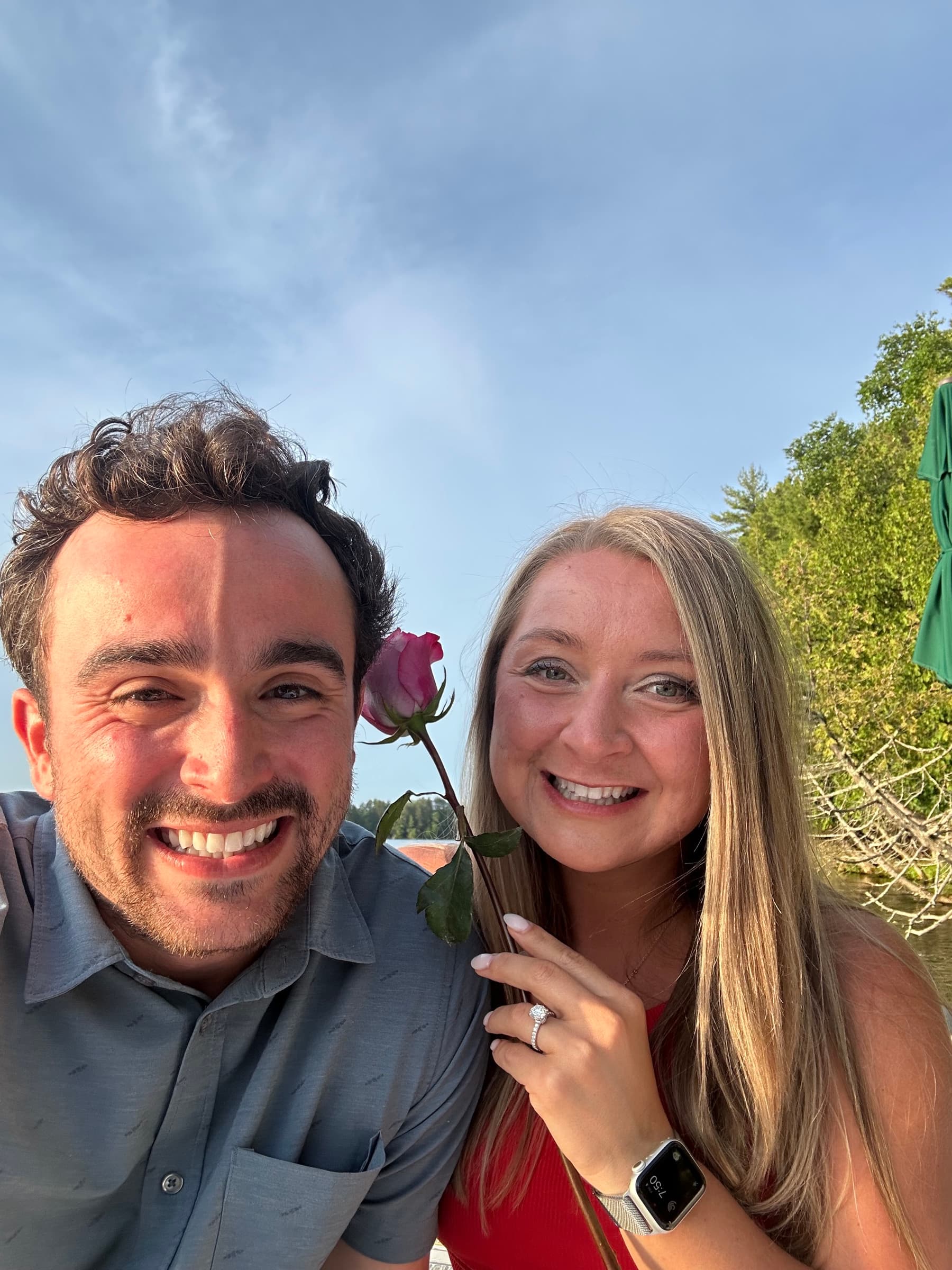 Taylor showing off her engagement ring with a rose