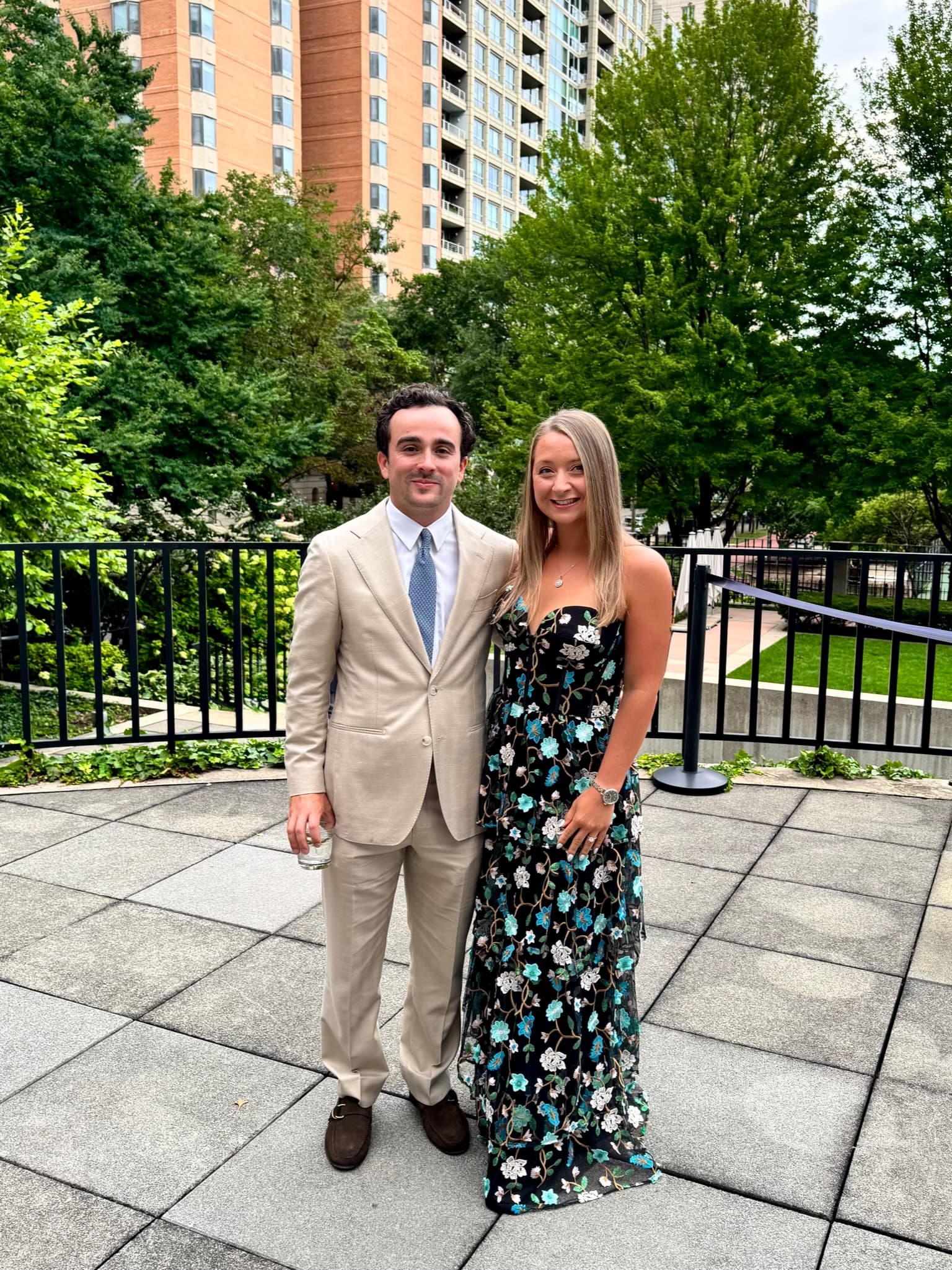 Dressed up together in a city courtyard with greenery