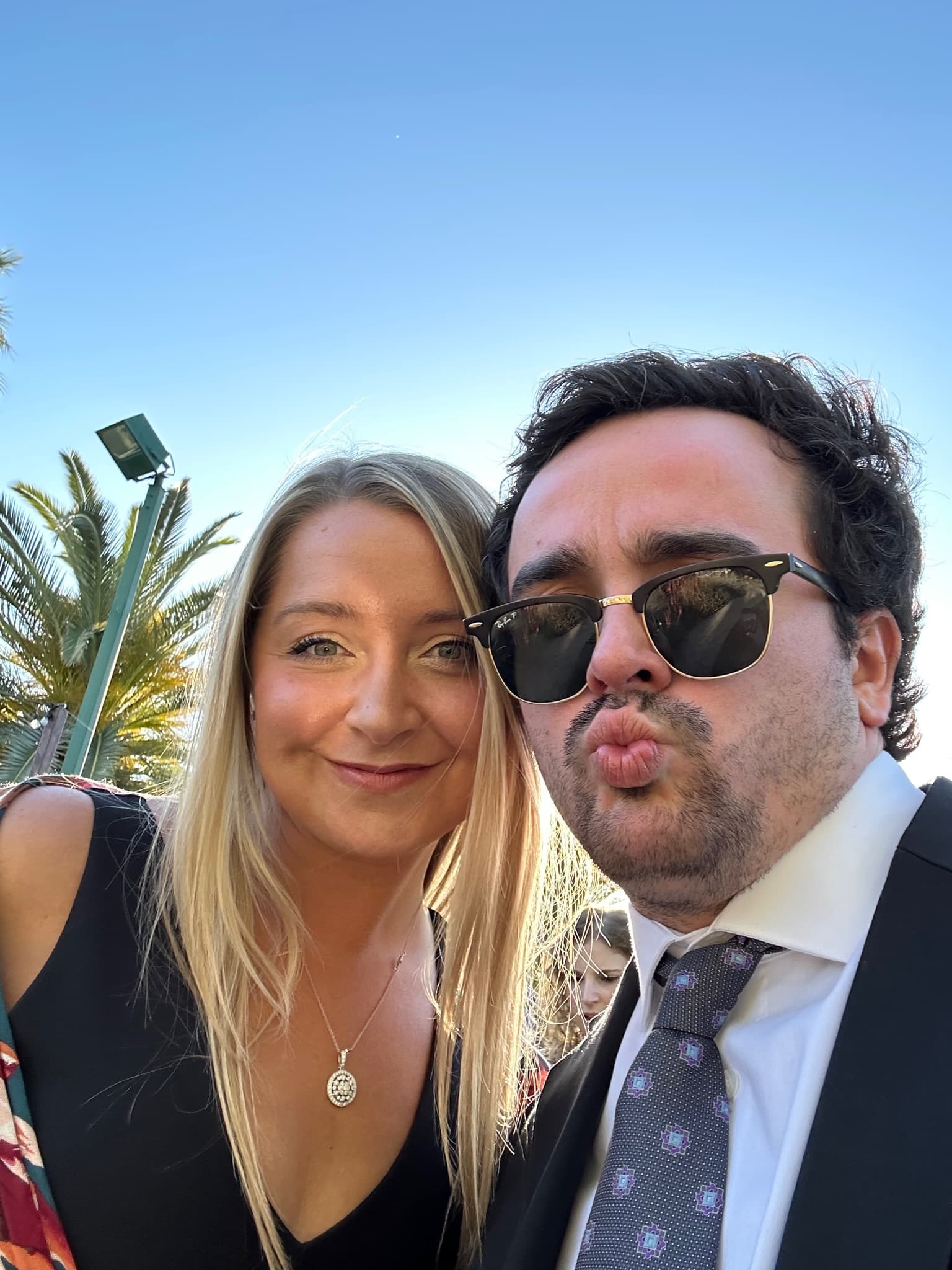 Fun selfie making faces with palm trees behind