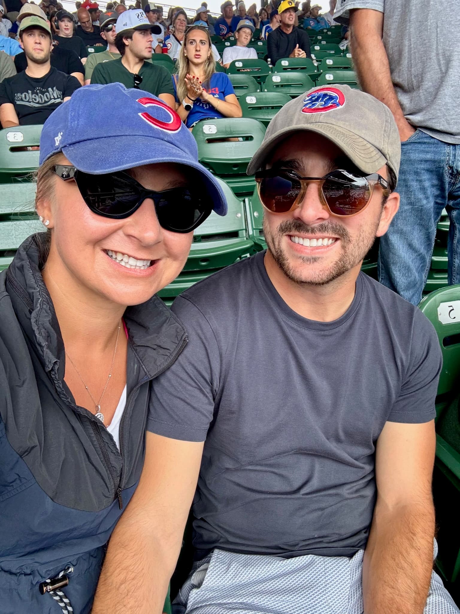 Selfie at a baseball game wearing Cubs hats