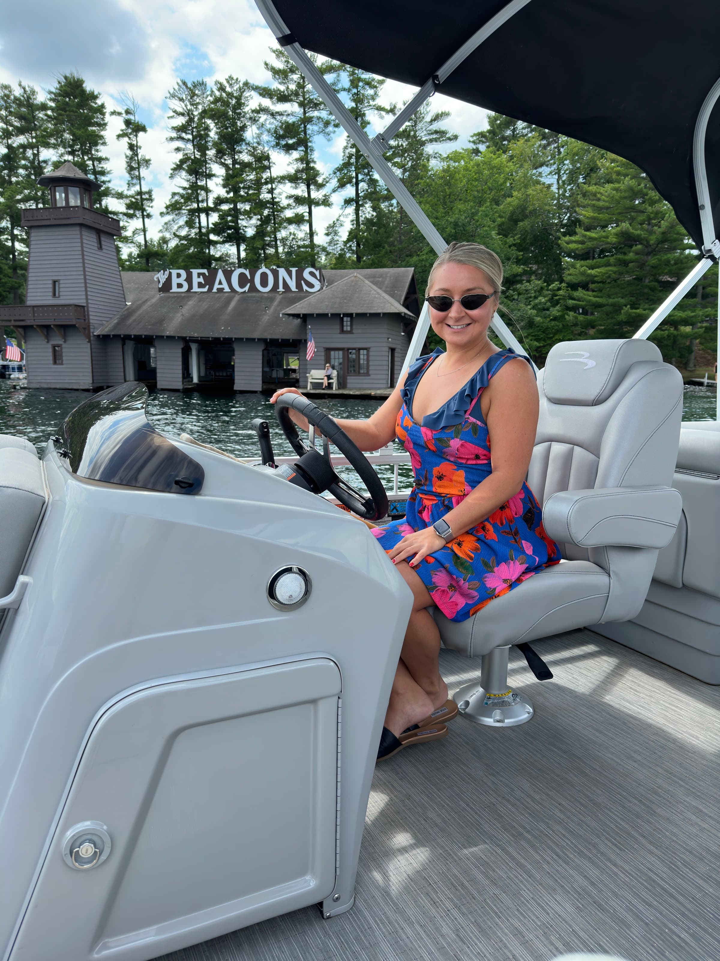 Taylor driving a pontoon boat on a lake