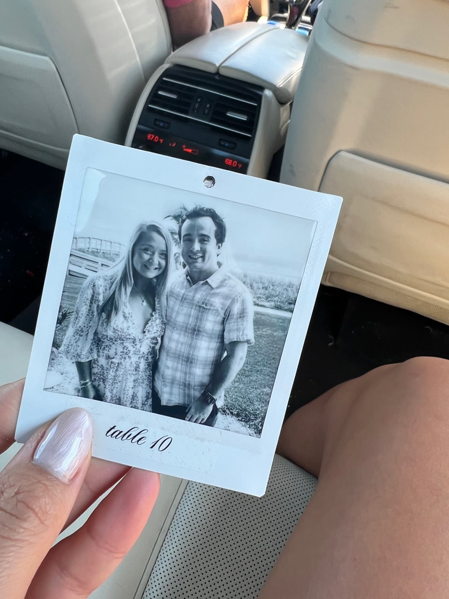 Holding a polaroid photo of the couple from a wedding