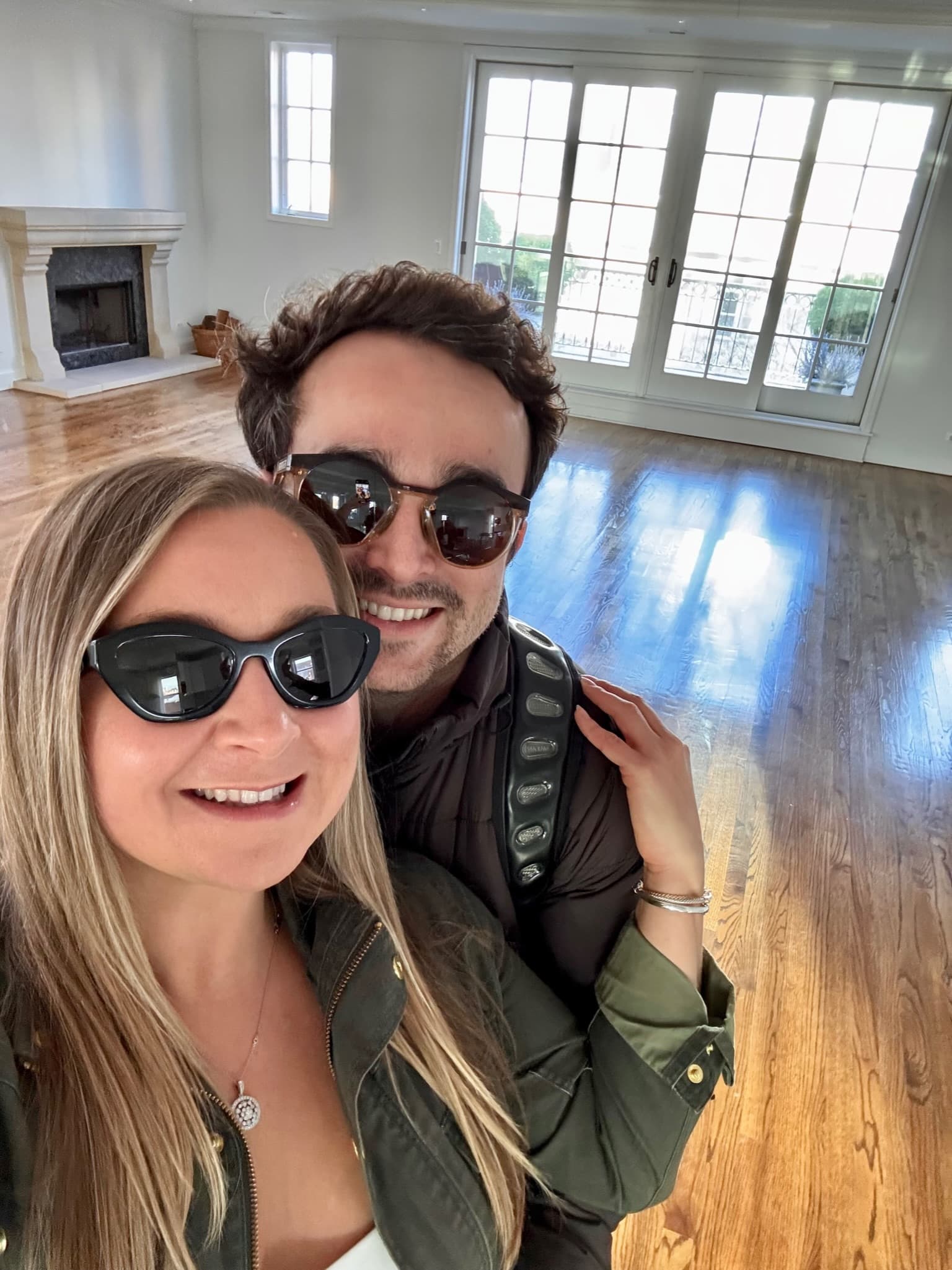 Excited selfie in their new empty home with hardwood floors
