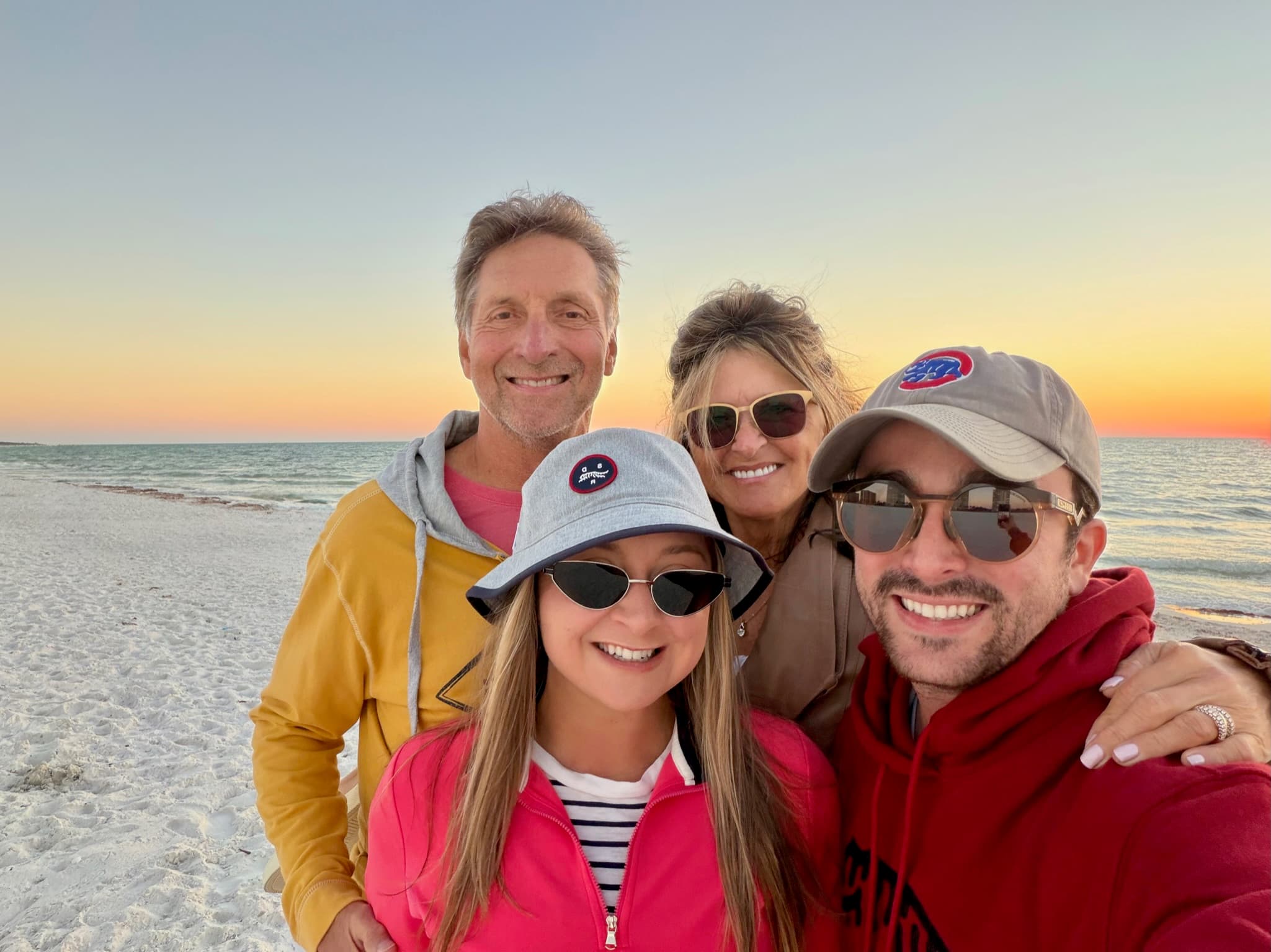 Beach sunset family selfie wearing hats and sunglasses