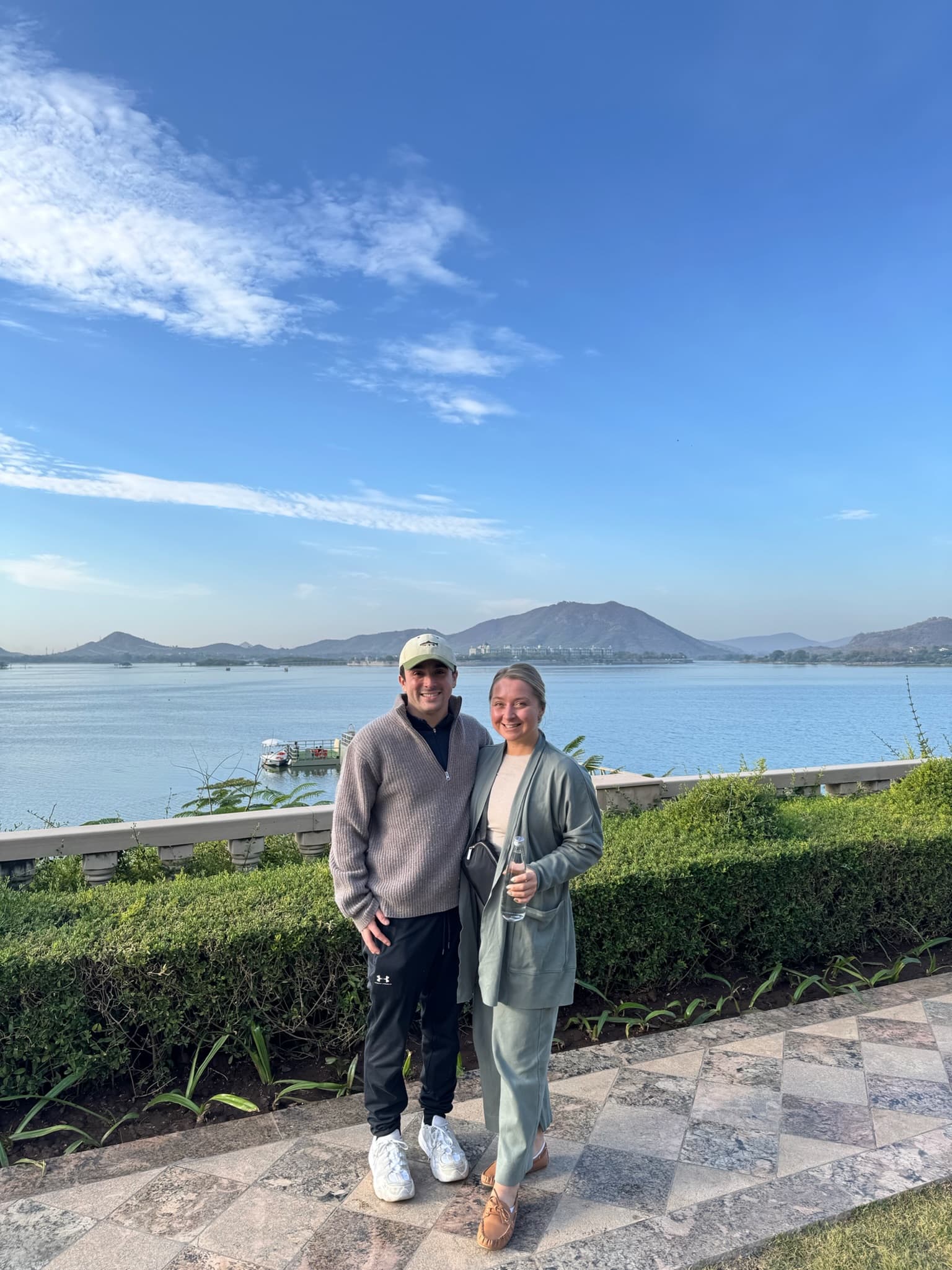 Posing by a lake with mountains in the background