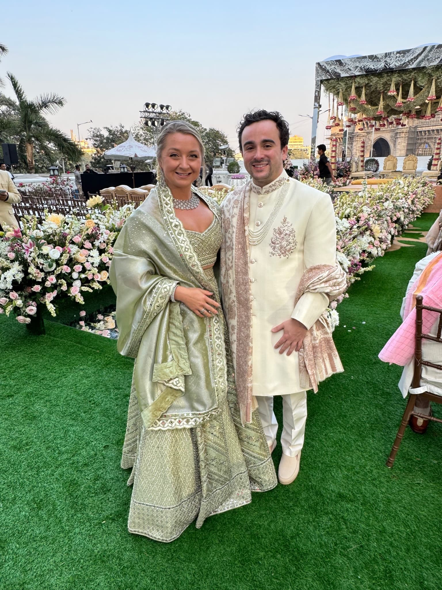 Dressed in formal Indian wedding attire among flowers