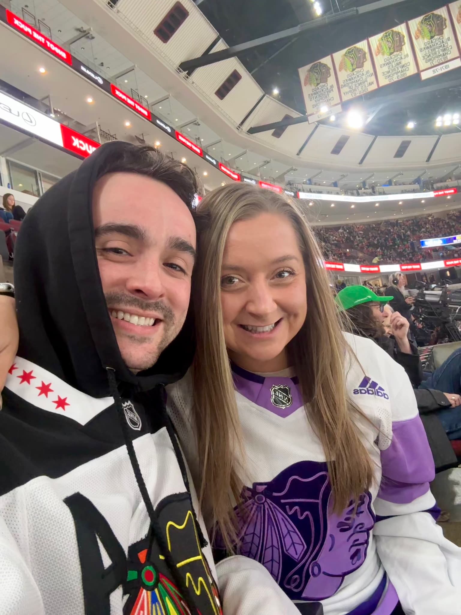 Selfie in Blackhawks jerseys at a hockey game