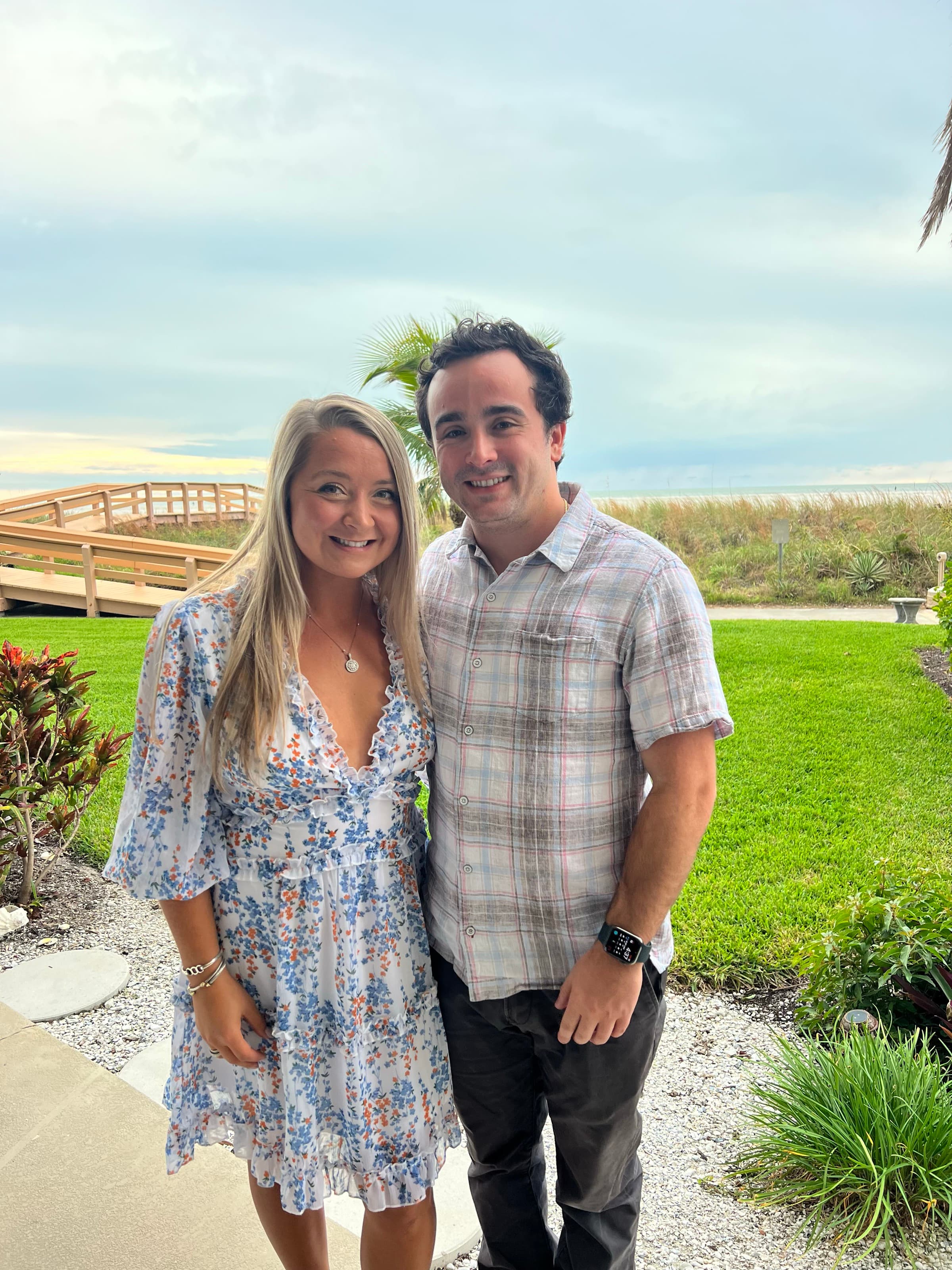 Standing together near the ocean at a tropical resort